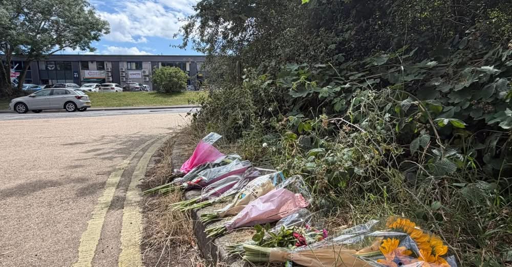 Bouquets of flowers left as a roadside memorial.