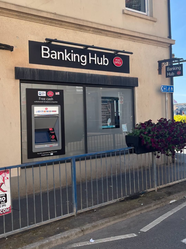 Totton Banking Hub with Post Office sign and ATM, offering free cash services.