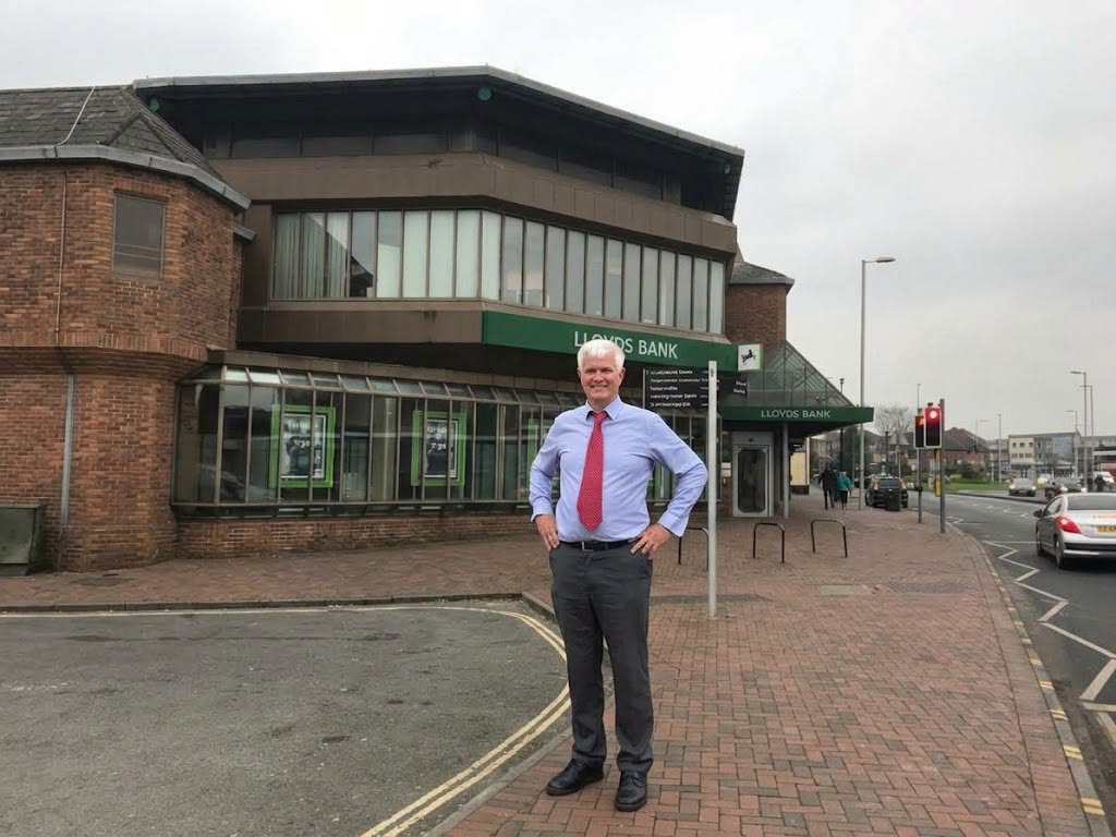 Man in front of a Lloyds Bank branch