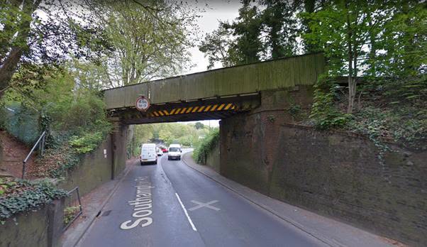 Bridge with height restriction sign, trucks passing under, Southampton Road.