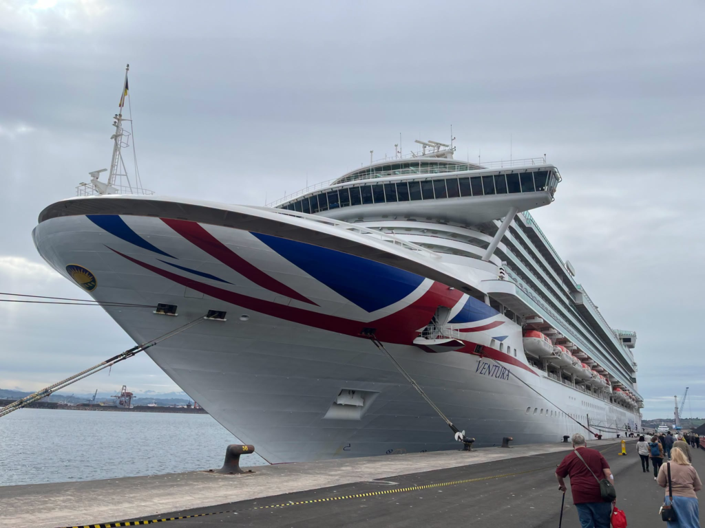 Large cruise ship Ventura docked at port, people boarding