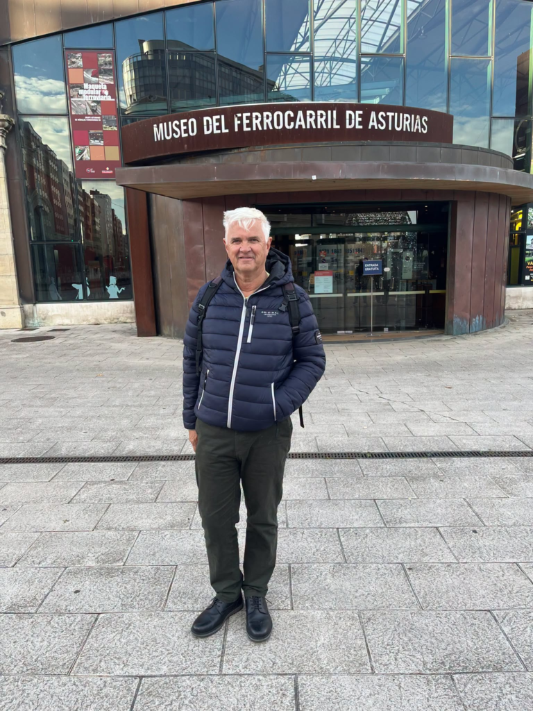 Man in front of the Asturias Railway Museum (Museo del Ferrocarril de Asturias)